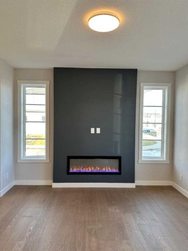 1189 Waterford Drive, Chestermere, AB - Indoor Photo Showing Other Room With Fireplace