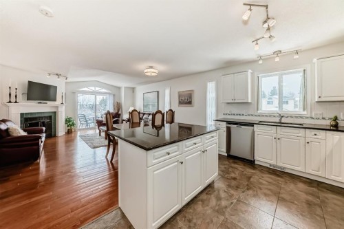 157 Hawkstone Manor Nw, Calgary, AB - Indoor Photo Showing Kitchen With Fireplace