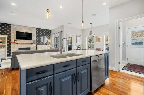 274 Somme Avenue Sw, Calgary, AB - Indoor Photo Showing Kitchen With Fireplace With Double Sink