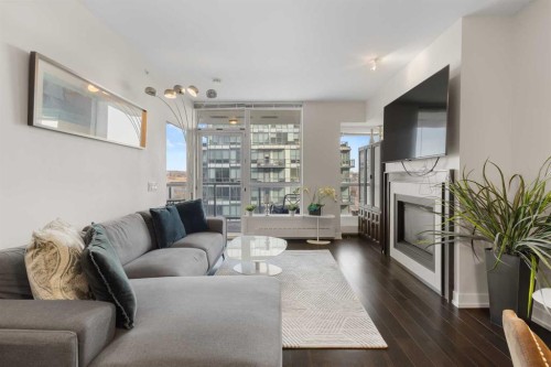 1322-222 Riverfront Avenue Sw, Calgary, AB - Indoor Photo Showing Living Room With Fireplace
