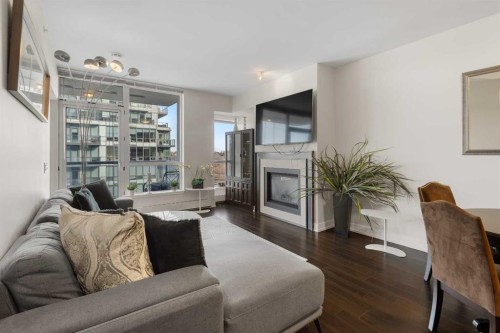 1322-222 Riverfront Avenue Sw, Calgary, AB - Indoor Photo Showing Living Room With Fireplace