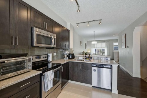 214 Nolanfield Villas Nw, Calgary, AB - Indoor Photo Showing Kitchen With Stainless Steel Kitchen With Double Sink With Upgraded Kitchen