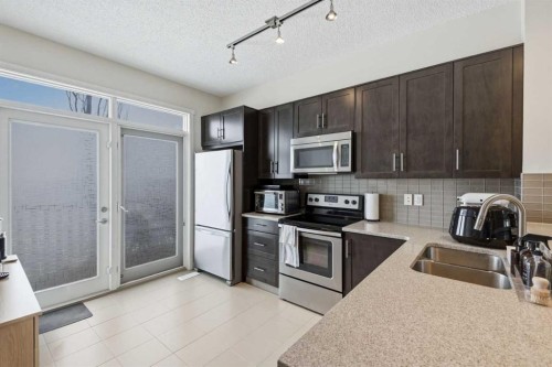 214 Nolanfield Villas Nw, Calgary, AB - Indoor Photo Showing Kitchen With Stainless Steel Kitchen With Double Sink