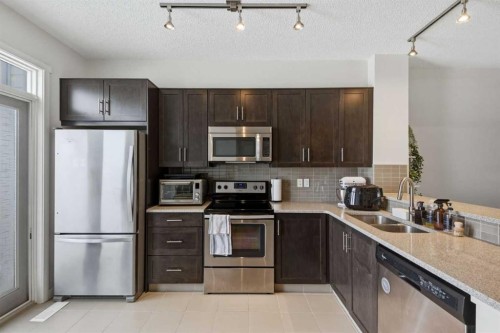 214 Nolanfield Villas Nw, Calgary, AB - Indoor Photo Showing Kitchen With Stainless Steel Kitchen With Double Sink With Upgraded Kitchen
