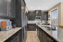 2 Ranchers Green, Okotoks, AB  - Indoor Photo Showing Kitchen With Stainless Steel Kitchen With Double Sink With Upgraded Kitchen 