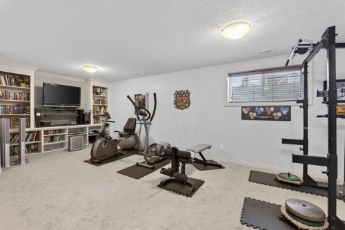 2 Ranchers Green, Okotoks, AB - Indoor Photo Showing Gym Room