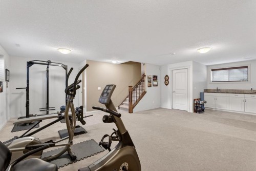 2 Ranchers Green, Okotoks, AB - Indoor Photo Showing Gym Room