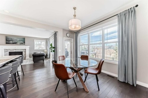 8 Masters Court Se, Calgary, AB - Indoor Photo Showing Dining Room With Fireplace
