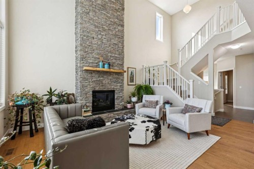 36 Sunrise Crescent, Cochrane, AB - Indoor Photo Showing Living Room With Fireplace