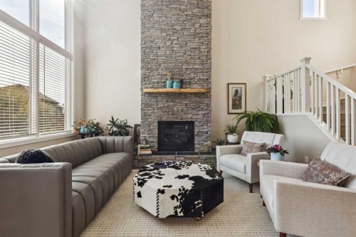 36 Sunrise Crescent, Cochrane, AB - Indoor Photo Showing Living Room With Fireplace