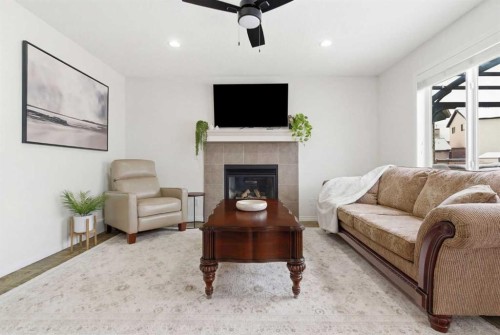 107 Cimarron Grove Circle, Okotoks, AB - Indoor Photo Showing Living Room With Fireplace