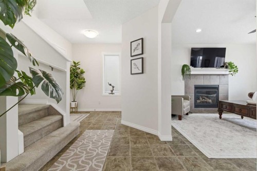 107 Cimarron Grove Circle, Okotoks, AB - Indoor Photo Showing Other Room With Fireplace