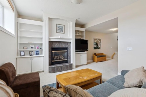 657 Woodside Court Nw, Airdrie, AB - Indoor Photo Showing Living Room With Fireplace
