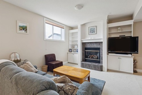 657 Woodside Court Nw, Airdrie, AB - Indoor Photo Showing Living Room With Fireplace