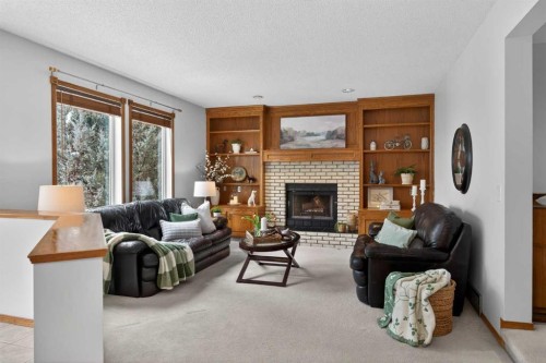 677 Hawkwood Boulevard Nw, Calgary, AB - Indoor Photo Showing Living Room With Fireplace
