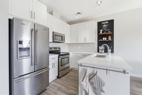 1208 Jumping Pound Common, Cochrane, AB - Indoor Photo Showing Kitchen With Upgraded Kitchen
