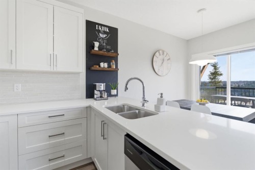 1208 Jumping Pound Common, Cochrane, AB - Indoor Photo Showing Kitchen With Double Sink With Upgraded Kitchen