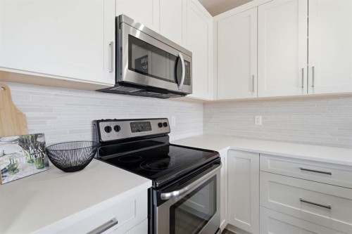 1208 Jumping Pound Common, Cochrane, AB - Indoor Photo Showing Kitchen