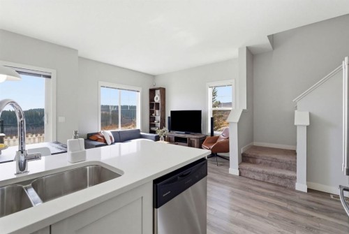 1208 Jumping Pound Common, Cochrane, AB - Indoor Photo Showing Kitchen With Double Sink