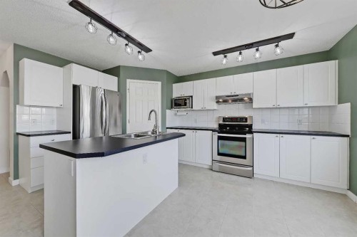 123 Arbour Butte Road Nw, Calgary, AB - Indoor Photo Showing Kitchen With Double Sink