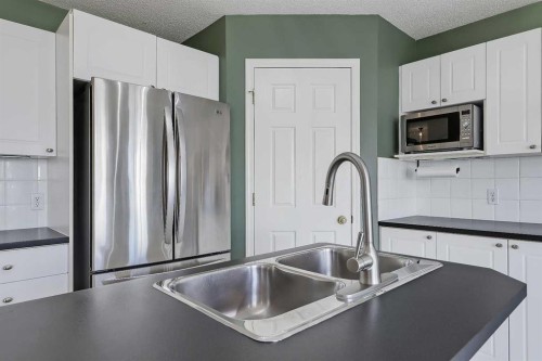 123 Arbour Butte Road Nw, Calgary, AB - Indoor Photo Showing Kitchen With Double Sink