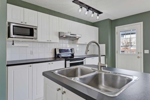 123 Arbour Butte Road Nw, Calgary, AB - Indoor Photo Showing Kitchen With Double Sink