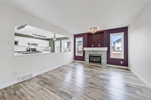 123 Arbour Butte Road Nw, Calgary, AB - Indoor Photo Showing Living Room With Fireplace