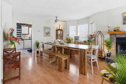 59 Abbeydale Villas Ne, Calgary, AB - Indoor Photo Showing Dining Room With Fireplace