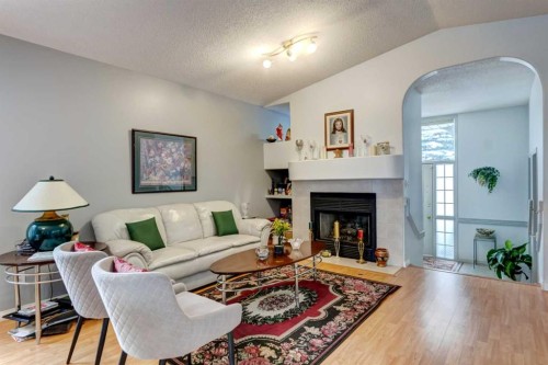 38 Millbank Hill Sw, Calgary, AB - Indoor Photo Showing Living Room With Fireplace