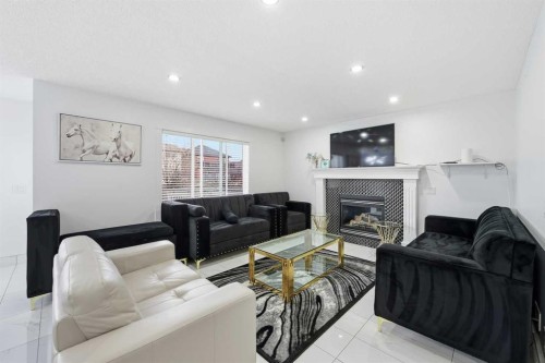 53 Martha'S Place Ne, Calgary, AB - Indoor Photo Showing Living Room With Fireplace