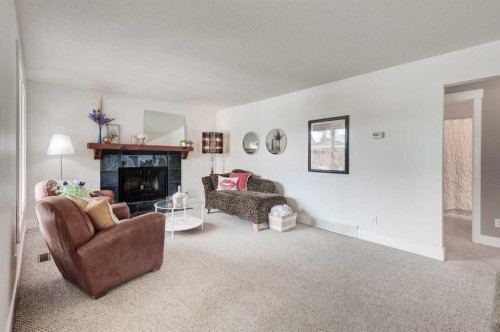 88 Sunhurst Road Se, Calgary, AB - Indoor Photo Showing Living Room With Fireplace