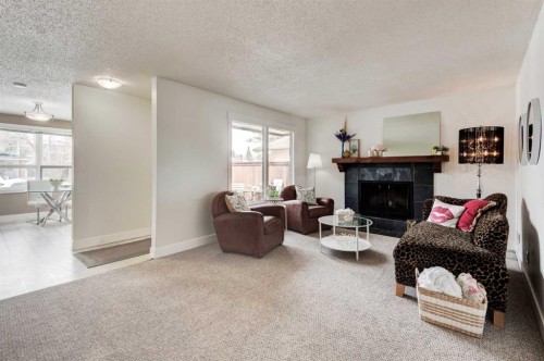 88 Sunhurst Road Se, Calgary, AB - Indoor Photo Showing Living Room With Fireplace