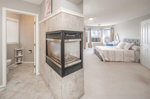 143 Hamptons Terrace Nw, Calgary, AB - Indoor Photo Showing Other Room With Fireplace