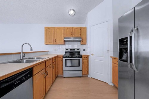 152 Saddlecreek Terrace Ne, Calgary, AB - Indoor Photo Showing Kitchen With Double Sink