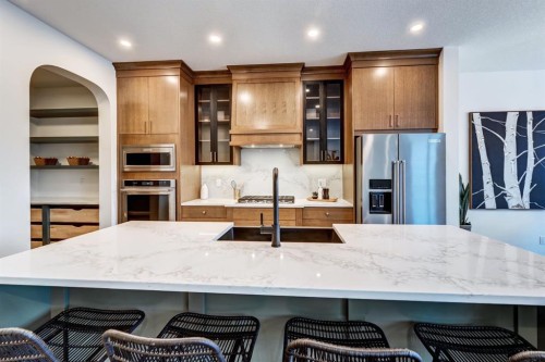 128 Sunrise Heath, Cochrane, AB - Indoor Photo Showing Kitchen With Upgraded Kitchen