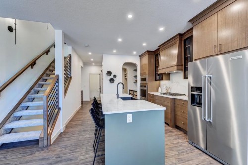 128 Sunrise Heath, Cochrane, AB - Indoor Photo Showing Kitchen With Upgraded Kitchen