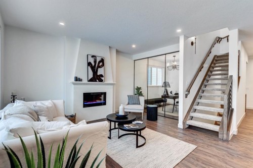 128 Sunrise Heath, Cochrane, AB - Indoor Photo Showing Living Room With Fireplace