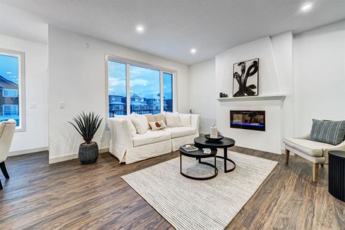 128 Sunrise Heath, Cochrane, AB - Indoor Photo Showing Living Room With Fireplace