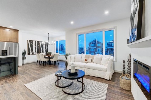 128 Sunrise Heath, Cochrane, AB - Indoor Photo Showing Living Room With Fireplace