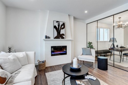 128 Sunrise Heath, Cochrane, AB - Indoor Photo Showing Living Room With Fireplace