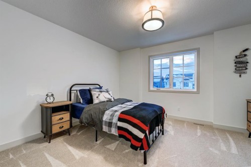 128 Sunrise Heath, Cochrane, AB - Indoor Photo Showing Bedroom