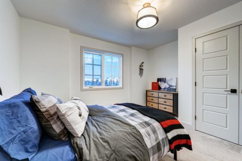 128 Sunrise Heath, Cochrane, AB - Indoor Photo Showing Bedroom
