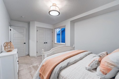128 Sunrise Heath, Cochrane, AB - Indoor Photo Showing Bedroom