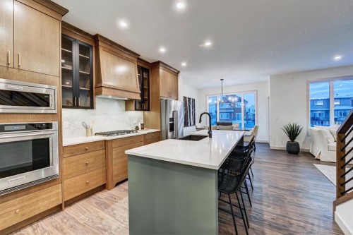 128 Sunrise Heath, Cochrane, AB - Indoor Photo Showing Kitchen With Upgraded Kitchen
