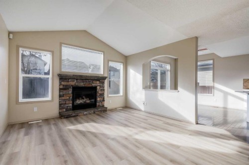 35 New Brighton Manor Se, Calgary, AB - Indoor Photo Showing Living Room With Fireplace