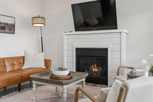 50 Riviera View, Cochrane, AB - Indoor Photo Showing Living Room With Fireplace