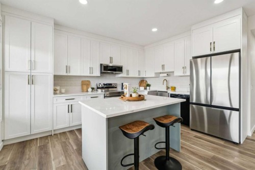 50 Riviera View, Cochrane, AB - Indoor Photo Showing Kitchen With Stainless Steel Kitchen With Upgraded Kitchen