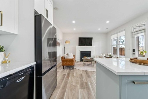 50 Riviera View, Cochrane, AB - Indoor Photo Showing Kitchen With Fireplace