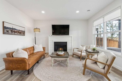 50 Riviera View, Cochrane, AB - Indoor Photo Showing Living Room With Fireplace