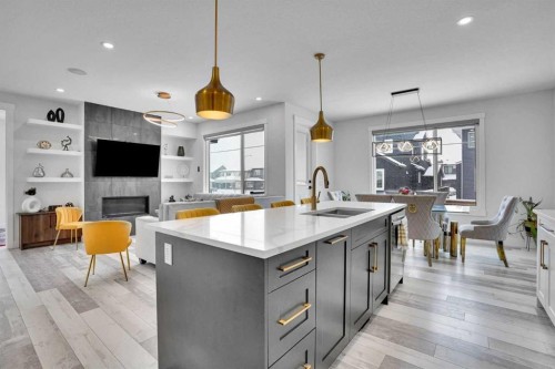 103 Sandpiper Park, Chestermere, AB - Indoor Photo Showing Kitchen With Fireplace With Double Sink